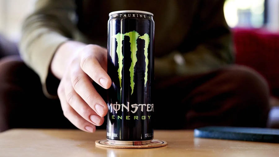 Image of a person reaching to grab Monster energy.