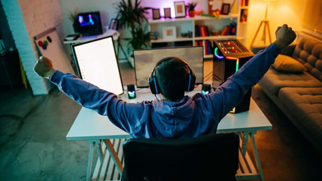 a picture of a player behind his gaming computer.