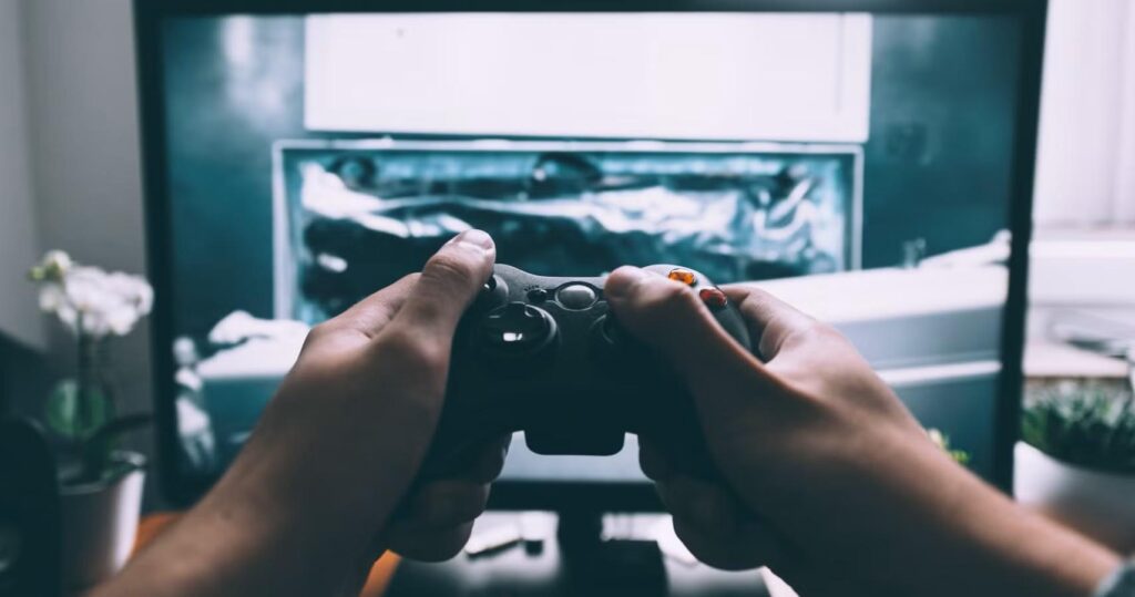 a picture of a hand holding an Xbox Controller.