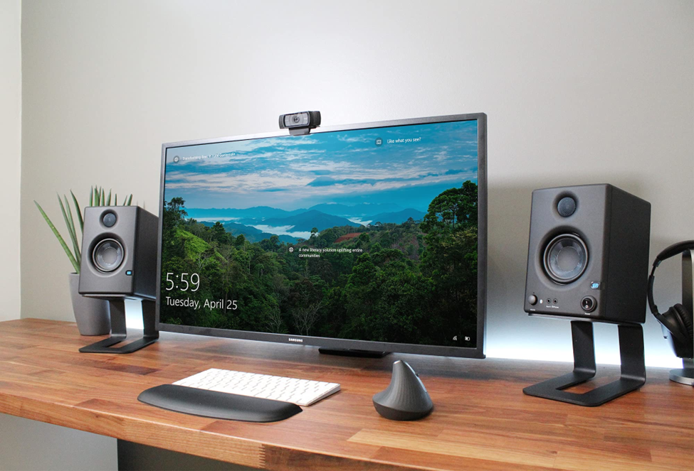 a wide monitor on a wooden table. 

