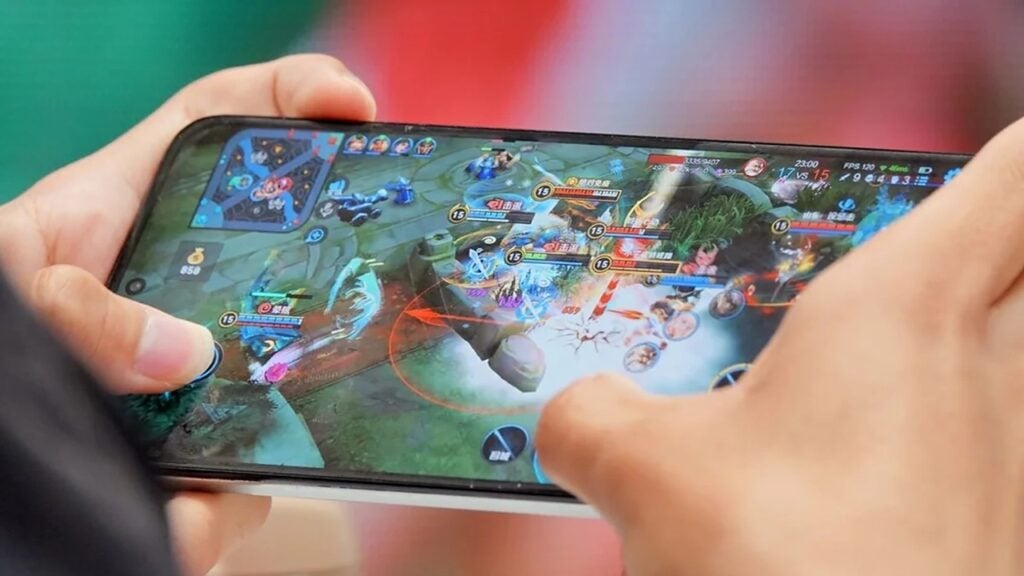an image of a gamer playing a video game with his smartphone